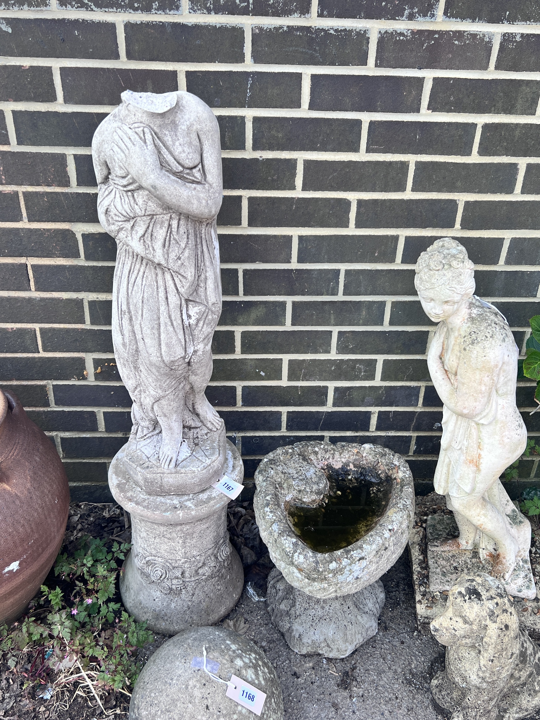 A reconstituted stone garden ornament of a robed lady, head detached, and a stone birdbath, tallest 120cm